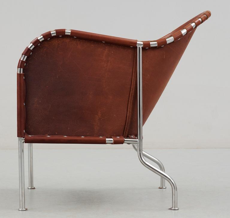 A Mats Theselius steel and brown leather easy chair.