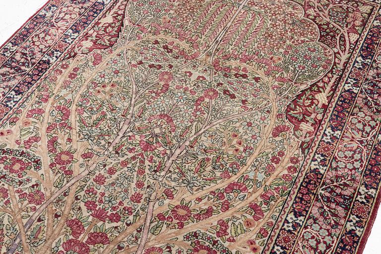 An antique Kirman rug, south Persia, c. 220 x 140 cm.