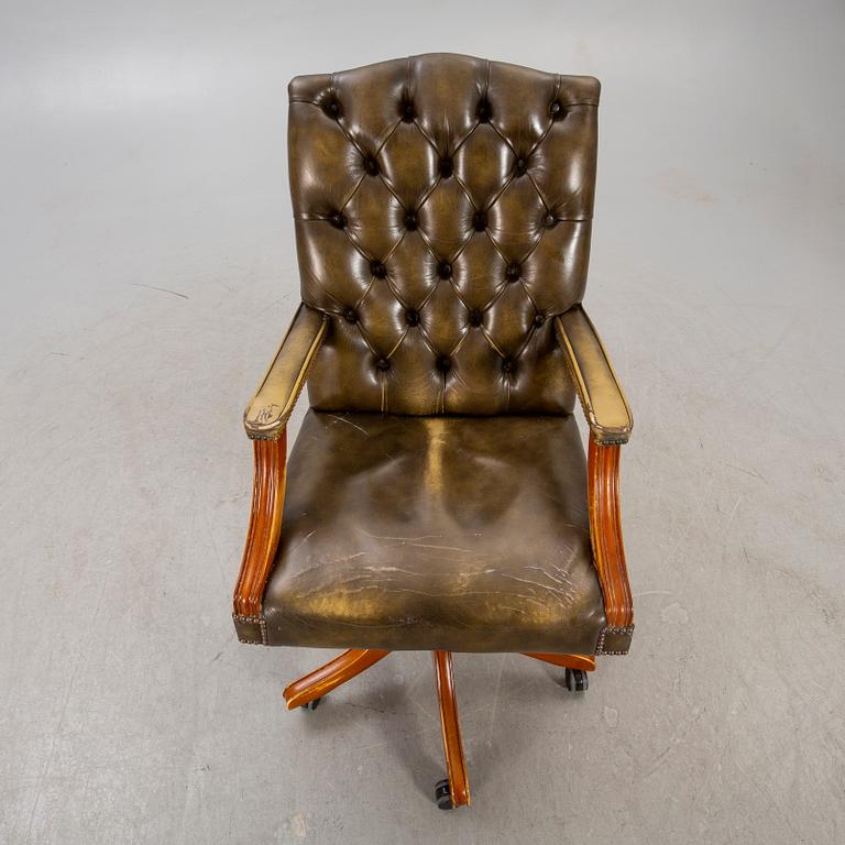 An English 21st century addjustable leather desk chair.