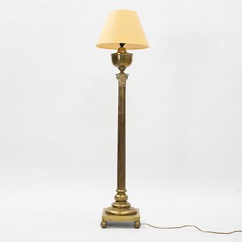 A brass floor lamp, circa 1900.