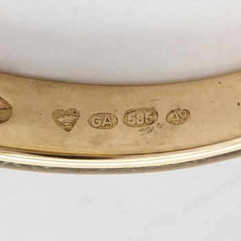 A half-eternity 14K gold ring with sapphires.