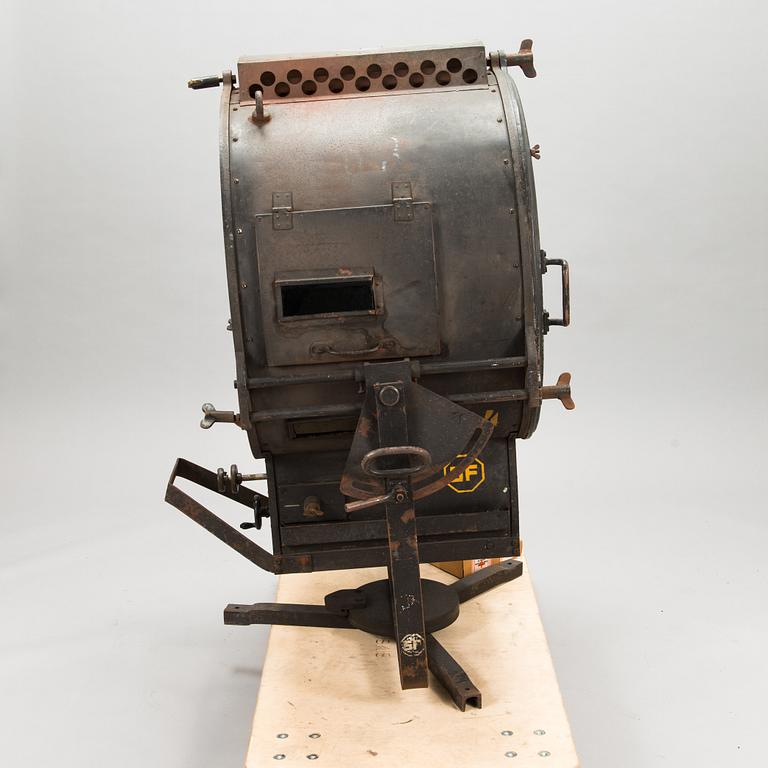 A film industry carbon arc spotlight with two boxes Kino-carbon sticks, + and -.