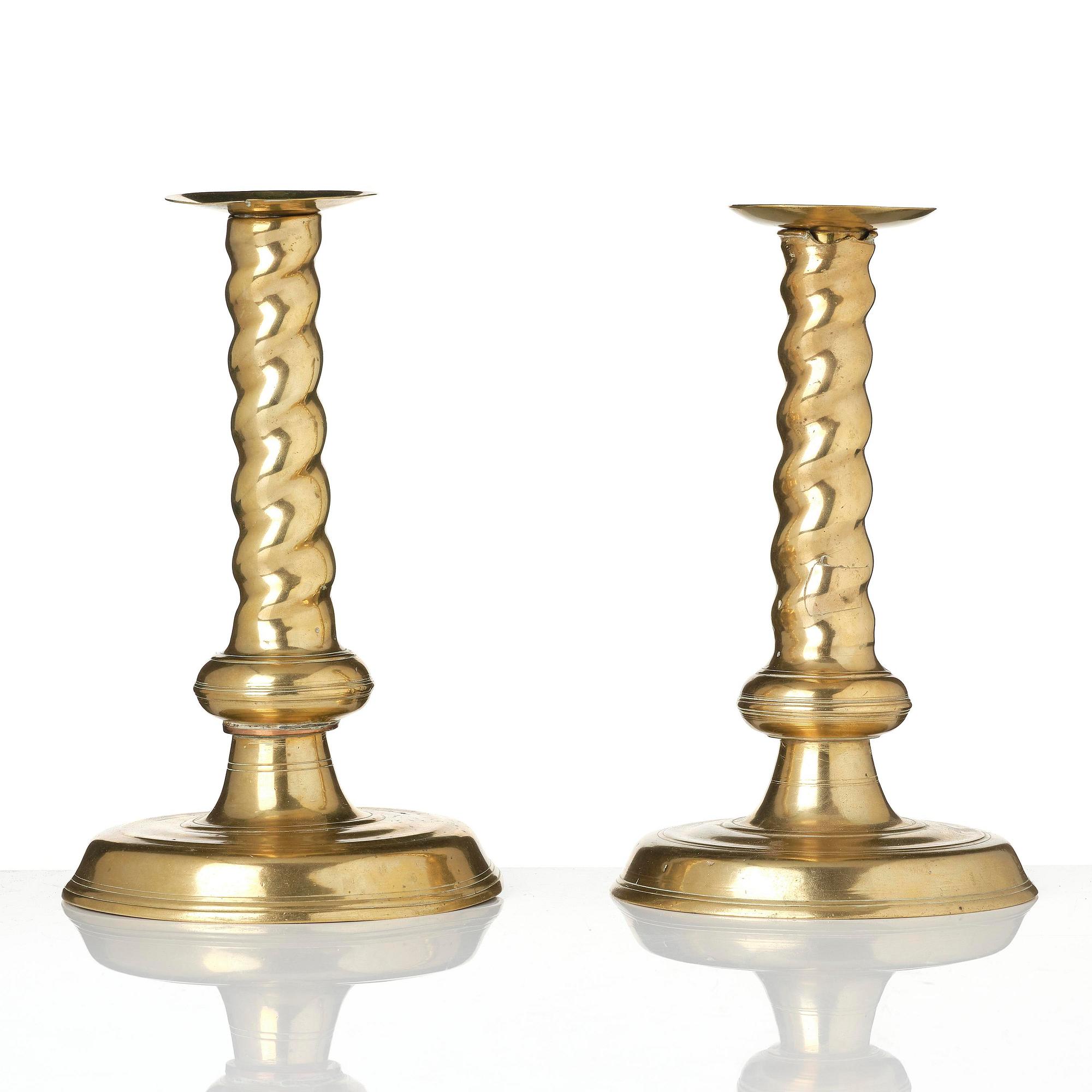 A pair of Northern European cast brass baroque candlesticks, circa 1700.
