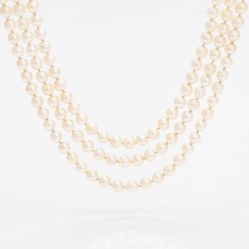 A three-strand pearl collier with cultured pearls and a 17K gold clasp with natural and synthetic sapphires.