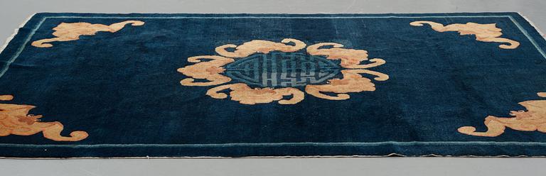 A carpet, a semi-antique Chinese,  ca 255 x 199-202,5 cm.