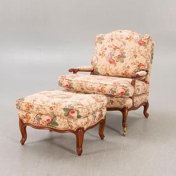 A Louis XV-style armchair and footstool later part of the 20th century.