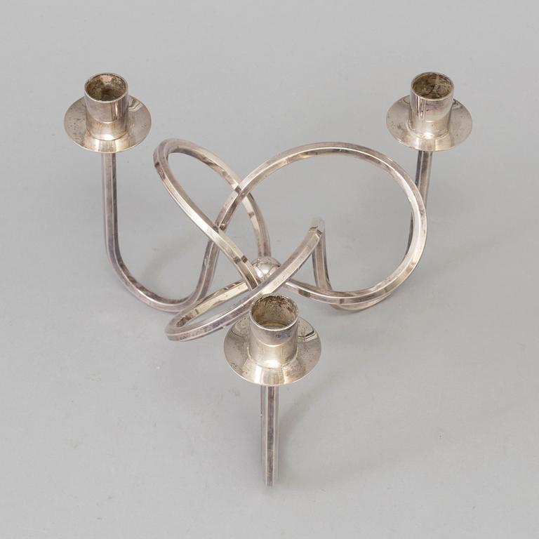 Josef Frank, a silver platen "Vänskapsknuten" candelabra ju Josef Frank för Firma Svenskt Tenn.