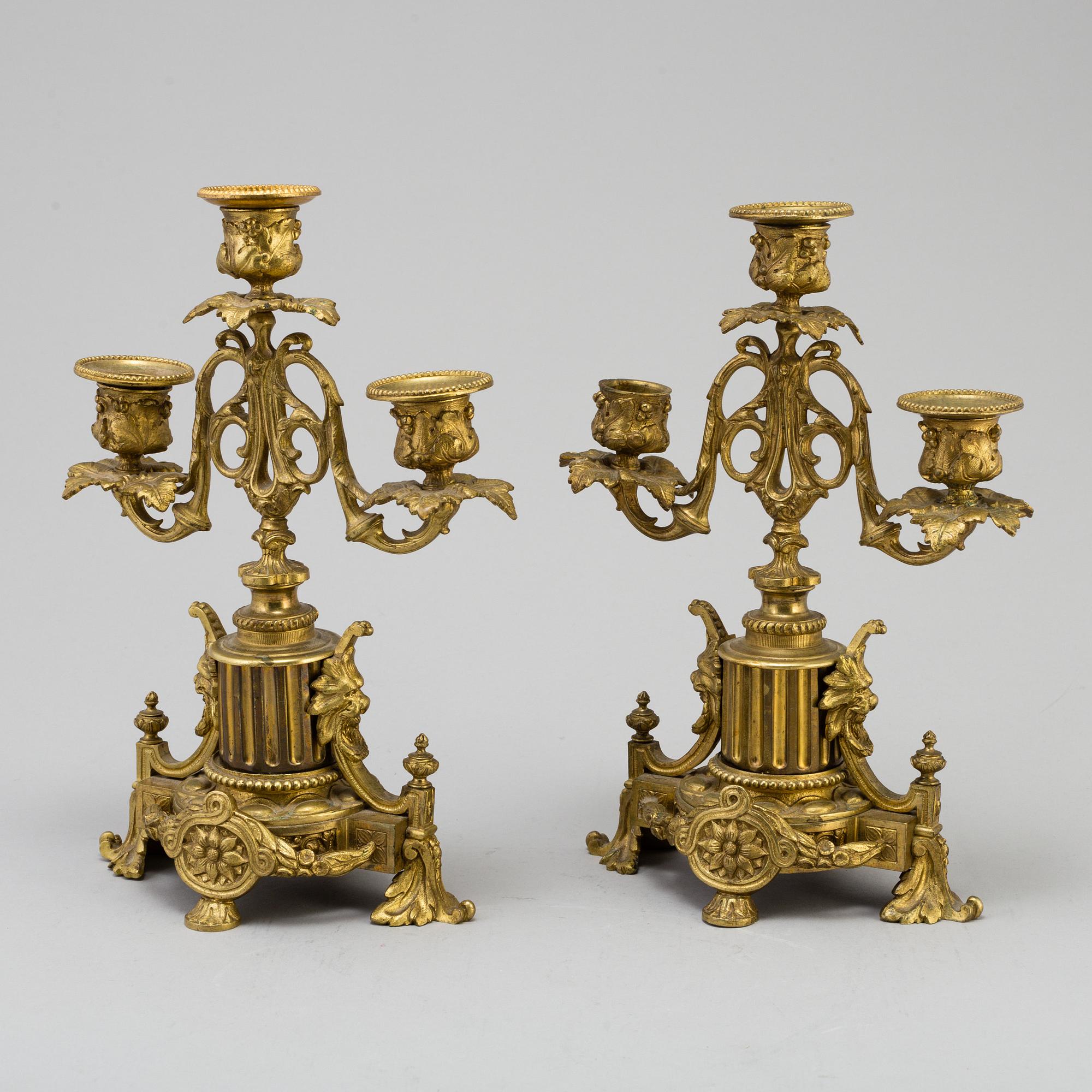 A table CLOCK and a pair of candelabra, second part of 19th century.