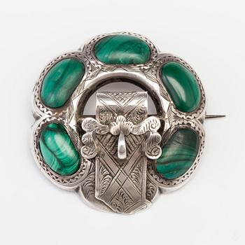 A BROOCH set with malachite.