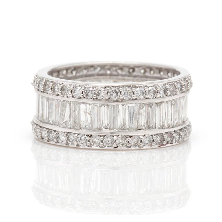 A ring with round, brilliant-cut and tapered, baguette-cut diamonds.