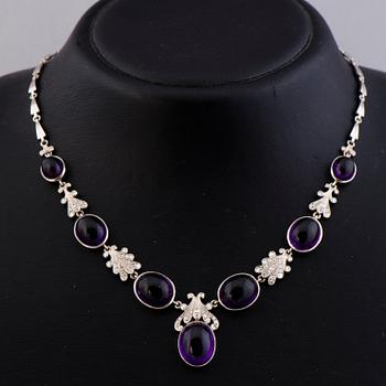 A NECKLACE, BRACELET, EARRINGS and RING, amethysts, diamnonds, 18K white gold and palladium. A. Tillander, 1970s.