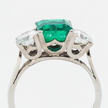 Emerald and brilliant-cut diamond three stone ring.