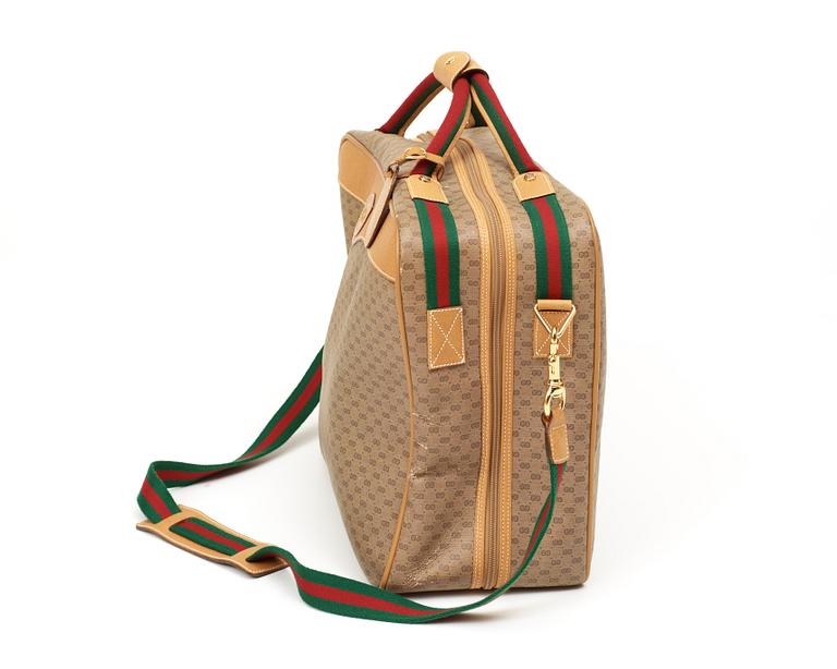 A weekend bag/ travelling bag by Gucci.