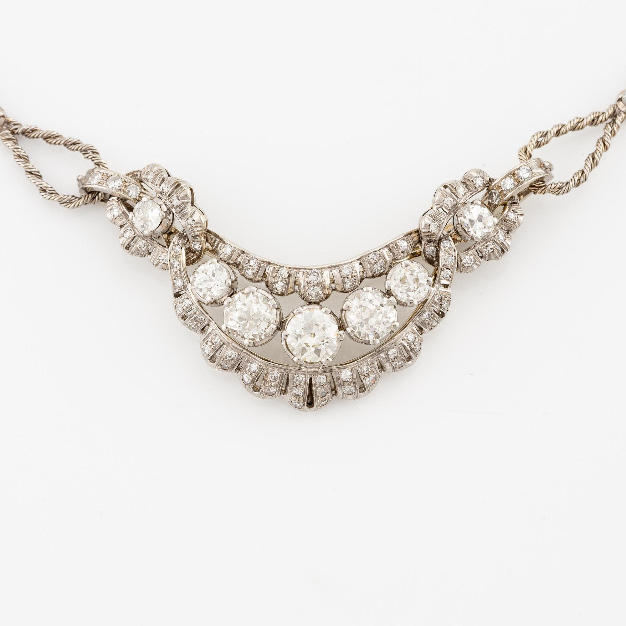 A brooch/necklace combination in 18K white gold set with old- and eight-cut diamonds.