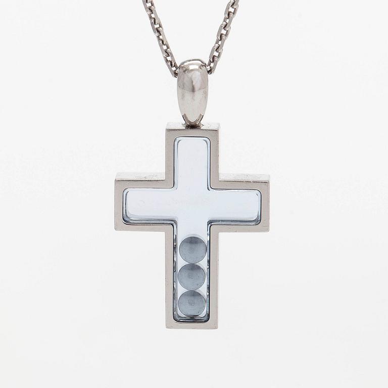 Chopard, an 18K whitegold 'Happy Diamonds" cross necklace set with diamonds.