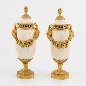 A pair of French Louis XVI-style Napoleon III gilt-bronze and marble urns, latet part of the 19th century.