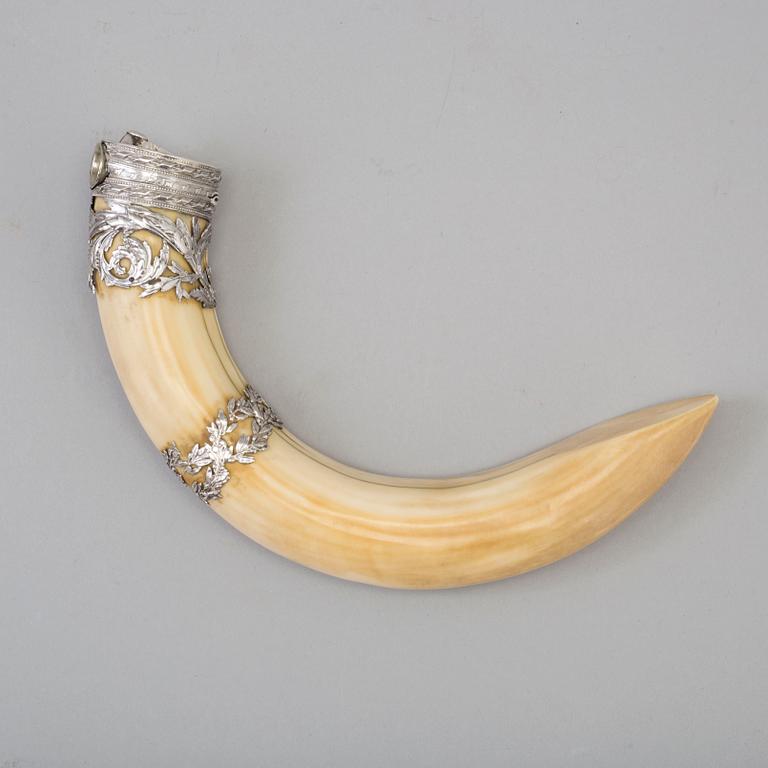 An early 20th century cigar cutter made of a wildboars tusk with silvermountings.