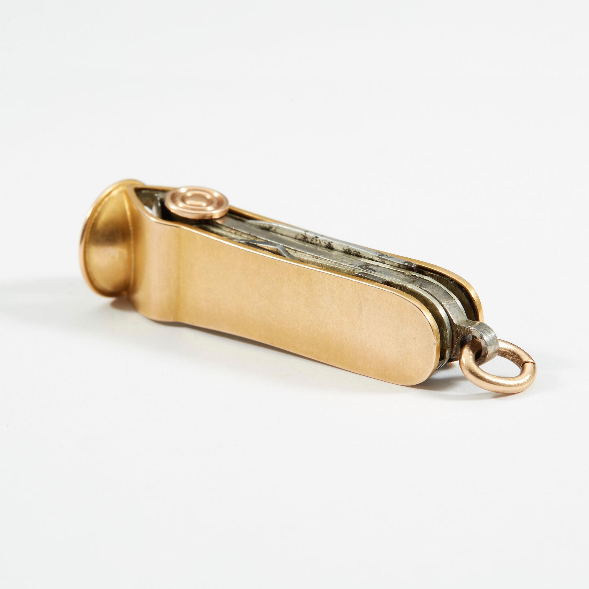 A Russian 20th century gold and metal cigar-cutter, unidentified makers mark, St. Petersburg 1908-1917.
