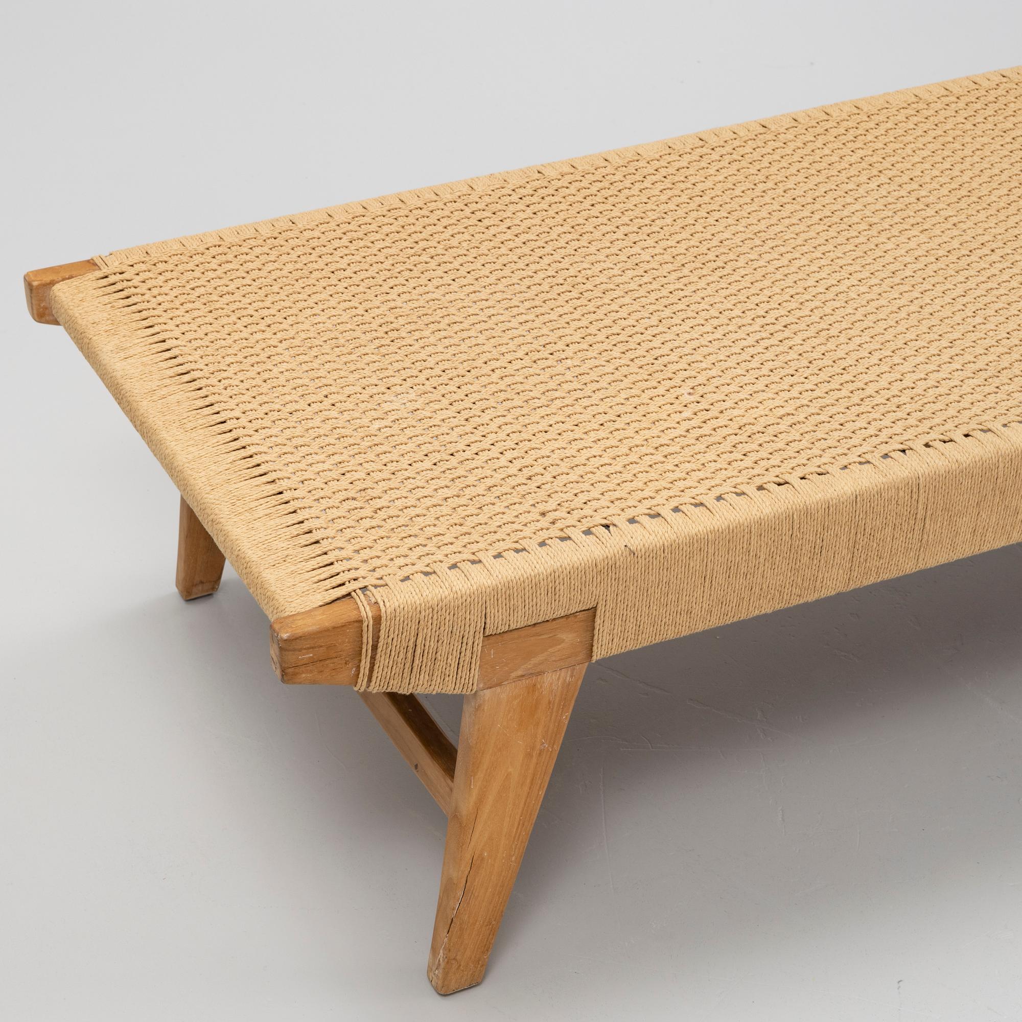 A contemporary teak daybed.