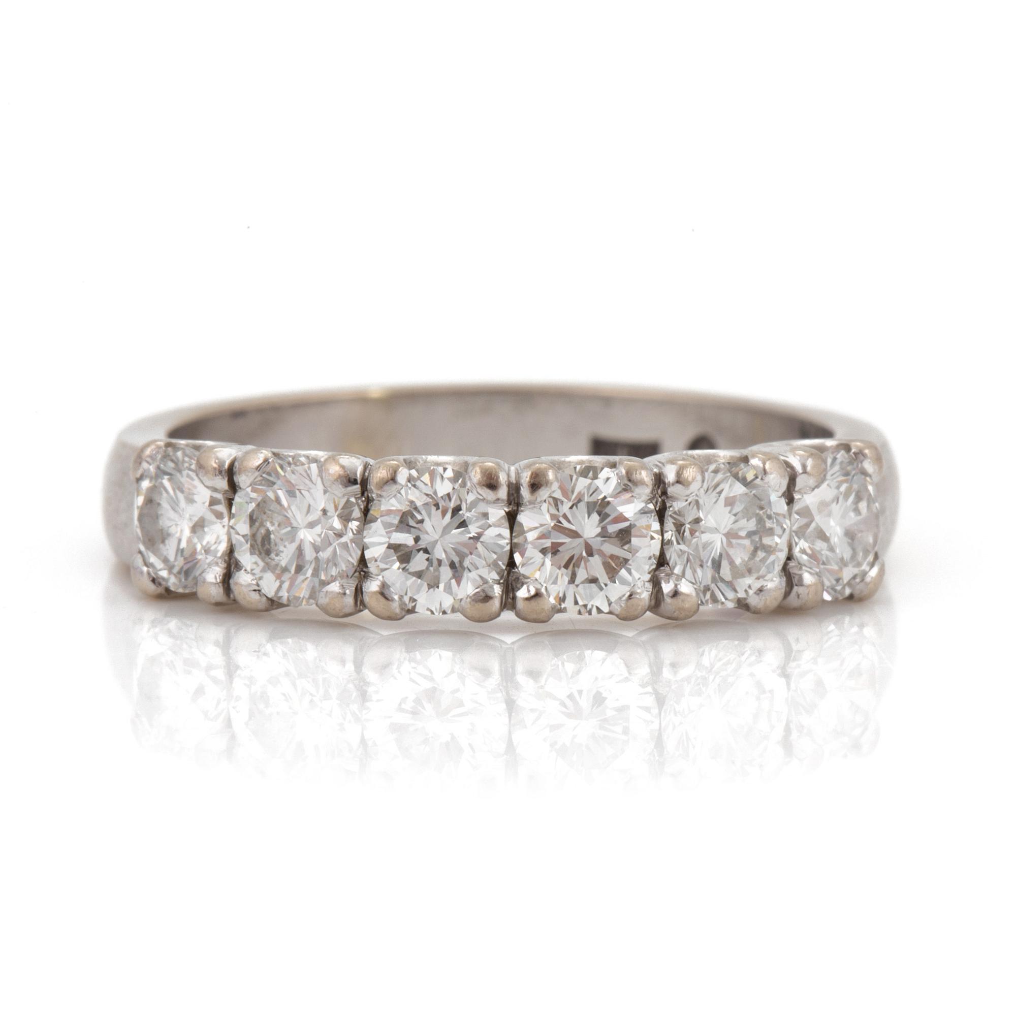 A half-eternity ring set with round, brilliant-cut diamonds.