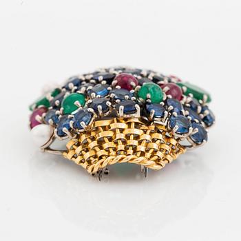 An 18K gold Carlman brooch set with sapphires, emeralds, rubies and pearls.