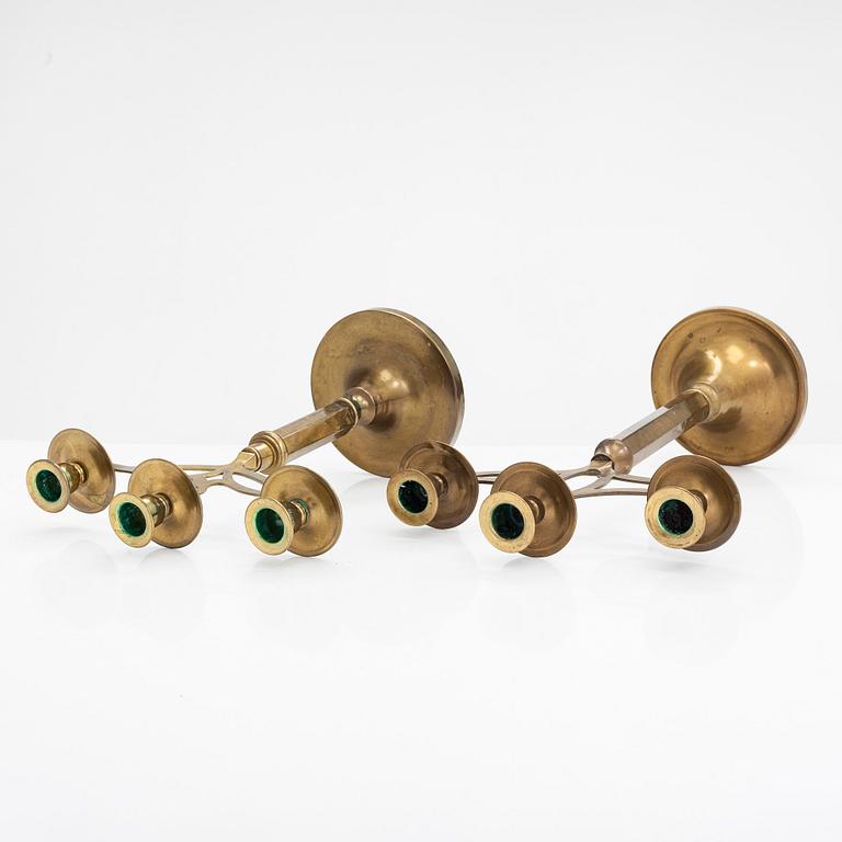 Three brass candlesticks from the early 20th Century.
