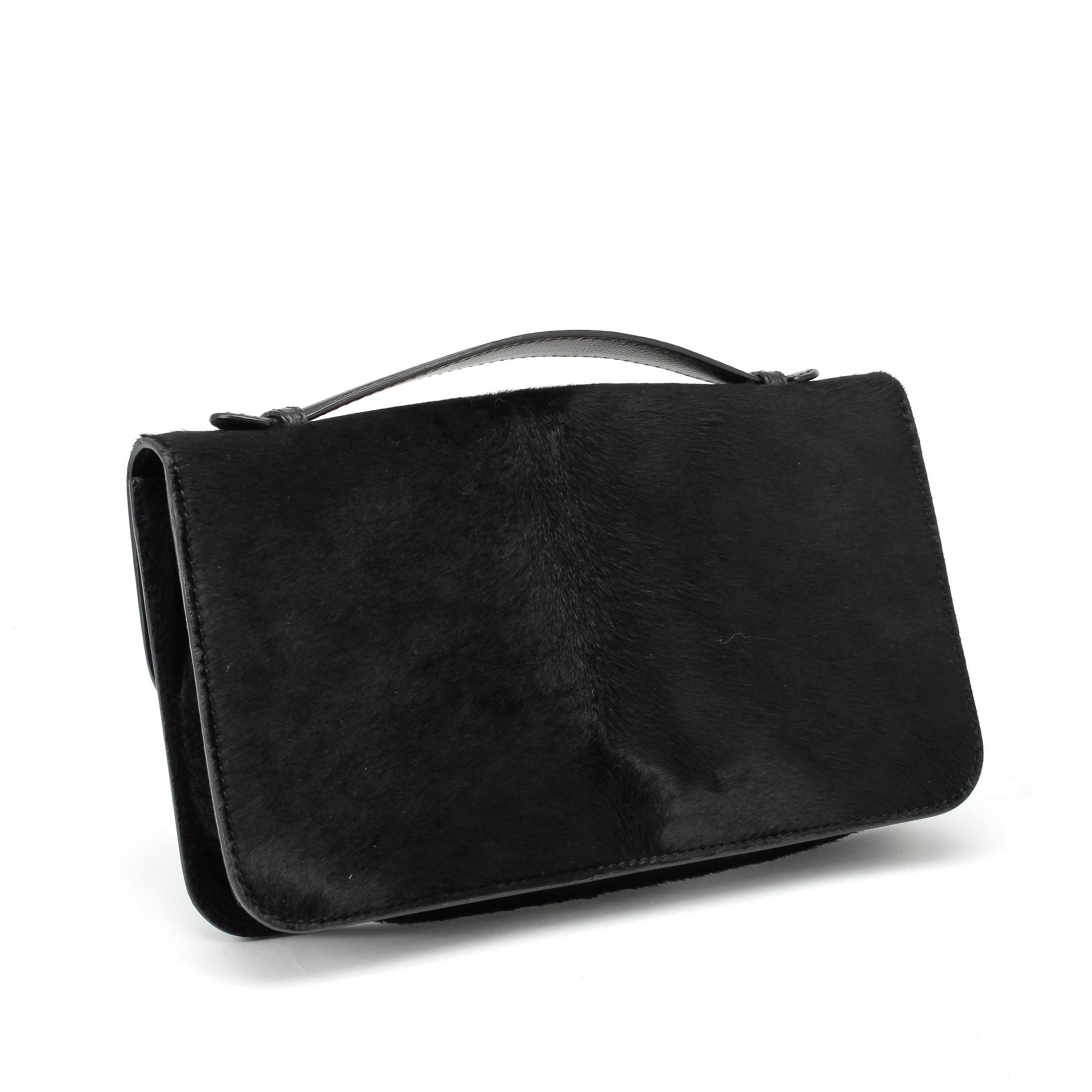 ALEXANDER MCQUEEN, a black pony hair clucth bag.
