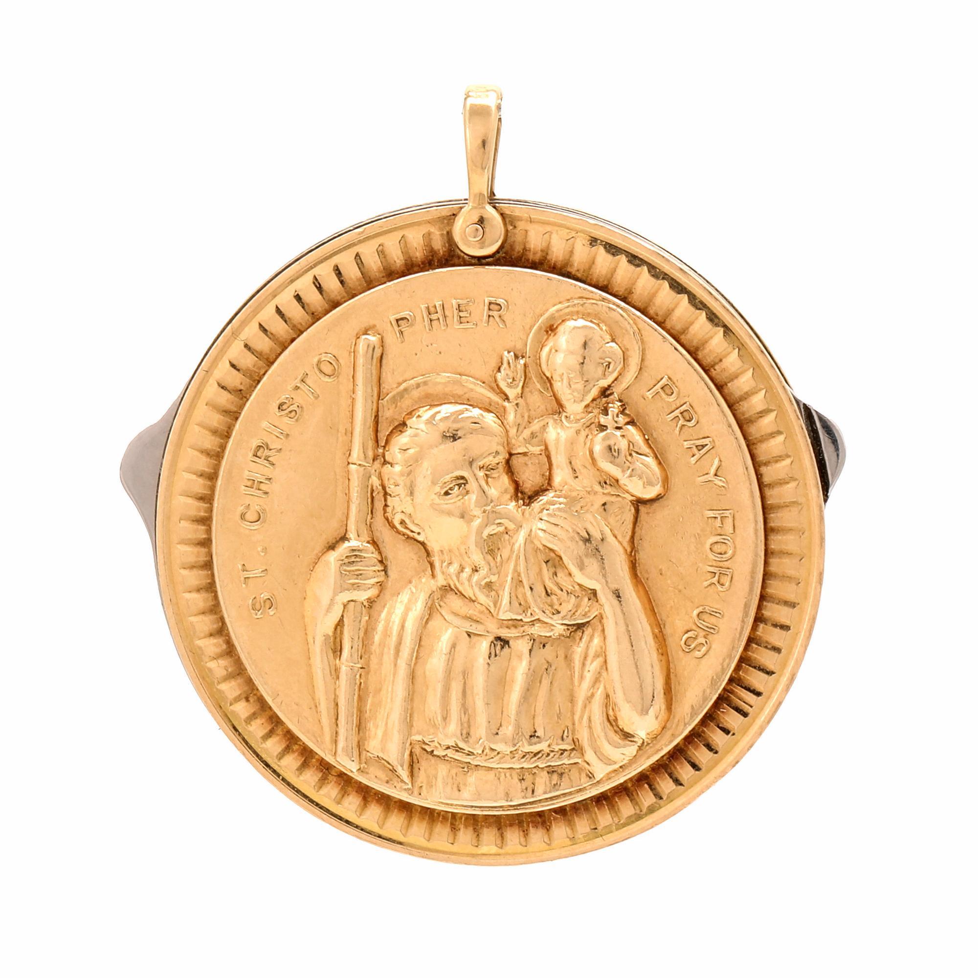 A 14K gold and steel medallion with knives.