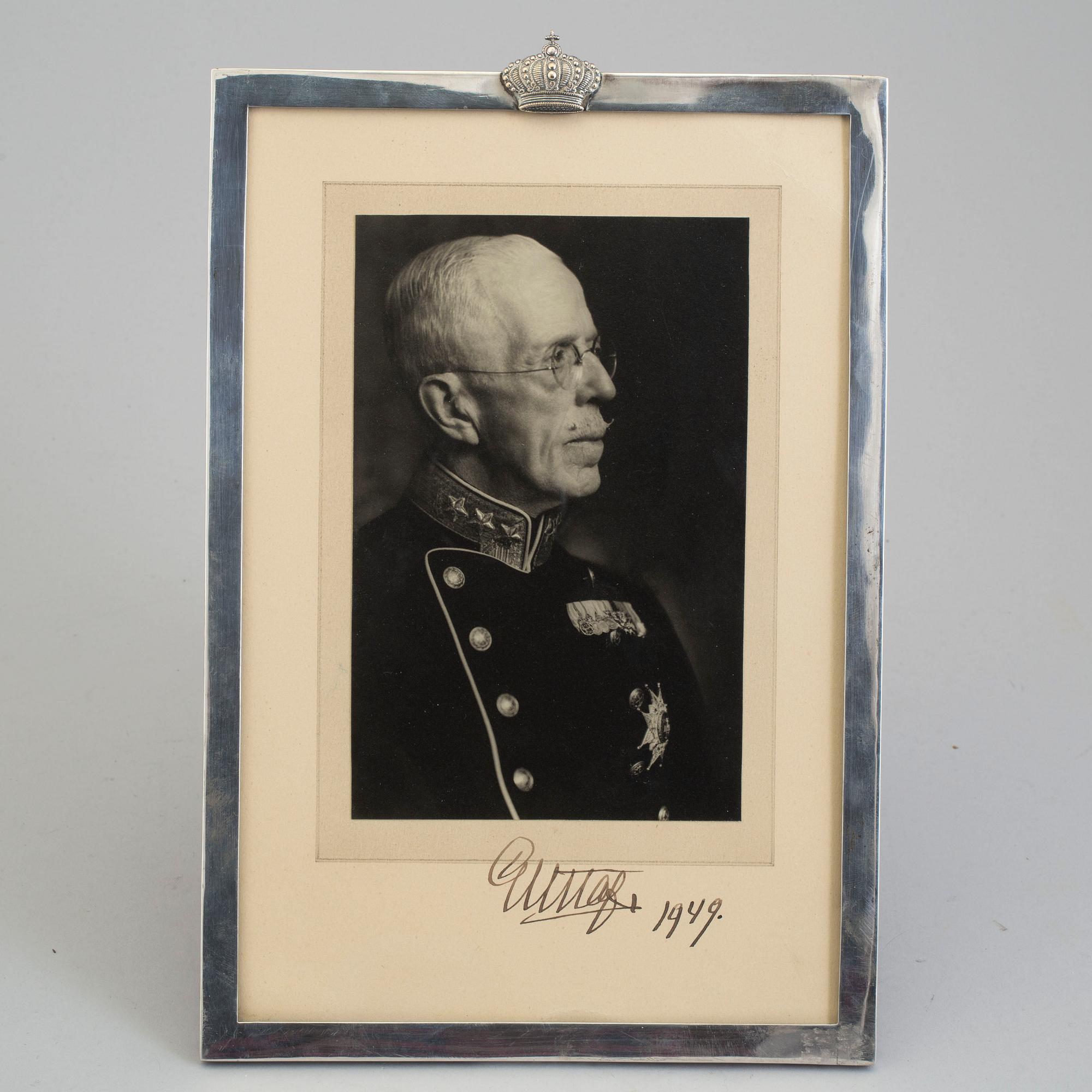 A signed photograph of King Gustav V of Sweden, dated 1949, in silver frame.