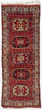 A semi-antique Kazak carpet, c. 335 x 123 cm.