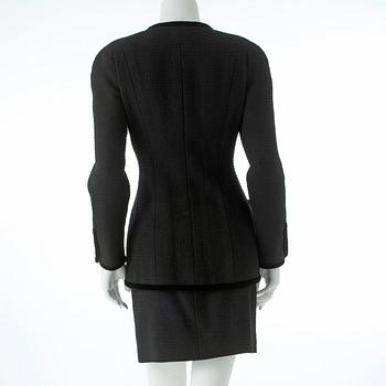 CHANEL, a two-piece suit consisting of jacket and skirt.