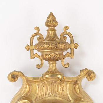 A bronze wall clock, Louis XVI style, France, circa 1900.