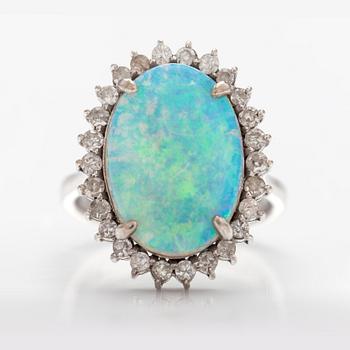 A 14K white gold ring with a probably real opal and diamonds ca. 0.65 ct in total.