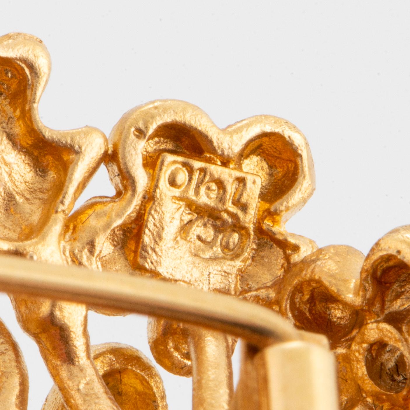 An 18K gold Ole Lynggaard brooch set with cultured pearls.