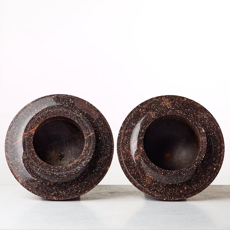 A pair of late Gustavian early 19th century porphyry urns with cover.