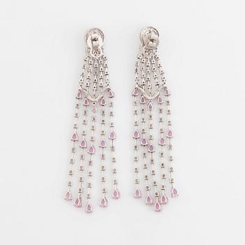 A pair of 18K white gold earrings set with faceted pink sapphires and round brilliant-cut diamonds.