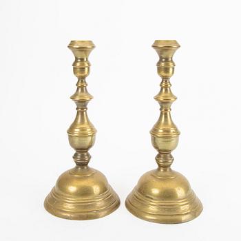 A pair of late 19th century brass candle sticks.