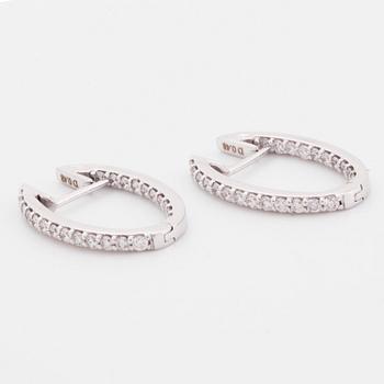 Brilliant-cut diamond hoop earrings.