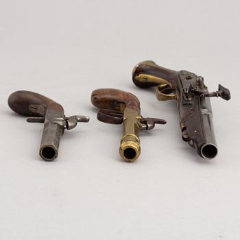 Two percussion and a flintlock pistol, 18th and 19th Century.