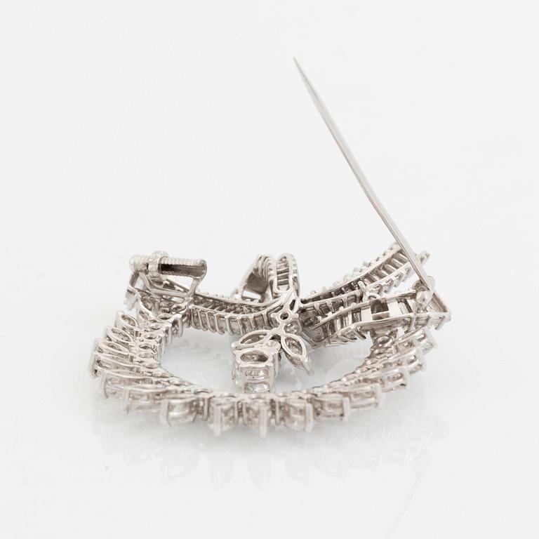 A platinum brooch set with navette-, tapered baguette- and brilliant-cut diamonds.