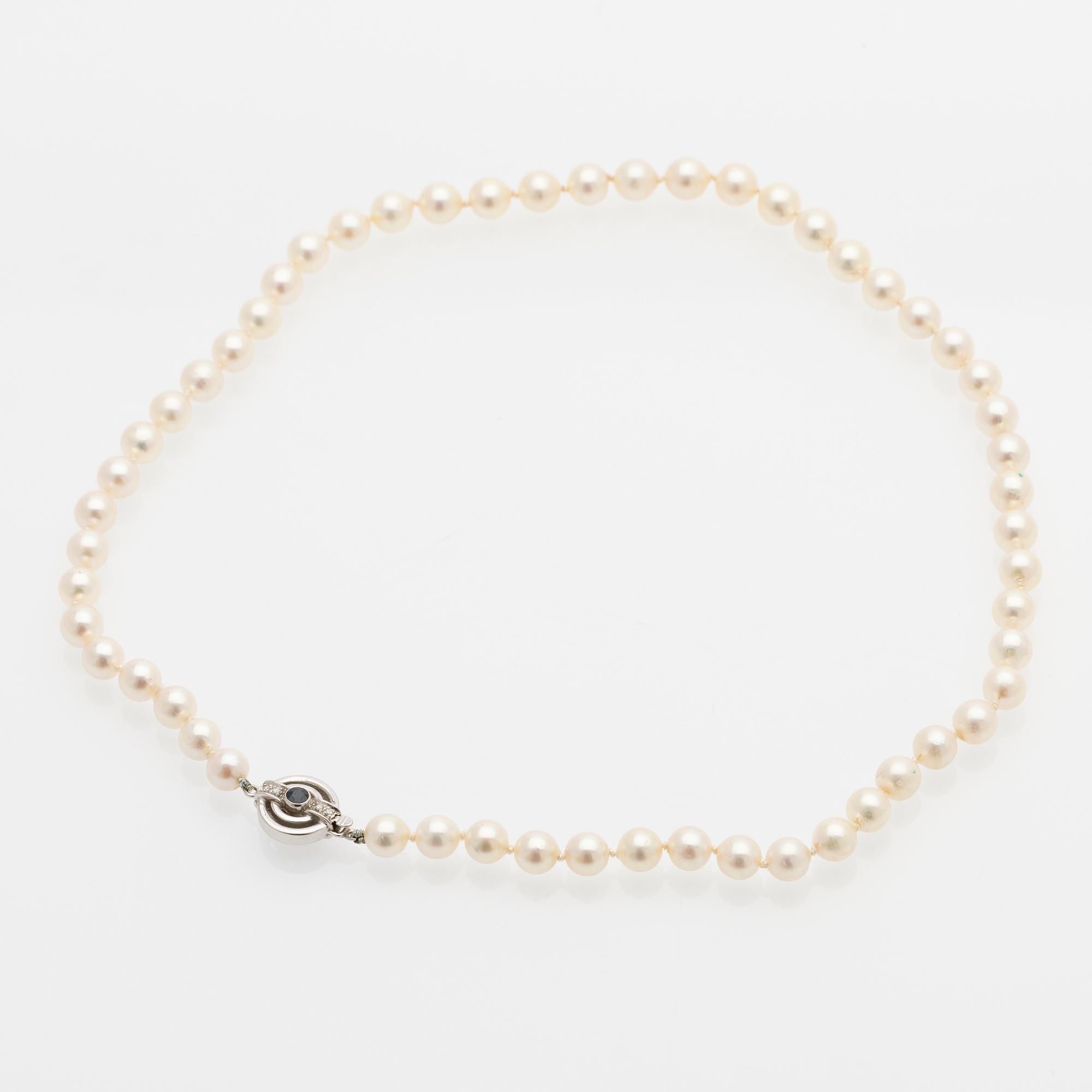 Pearl necklace, white gold clasp set with diamonds and a sapphire.