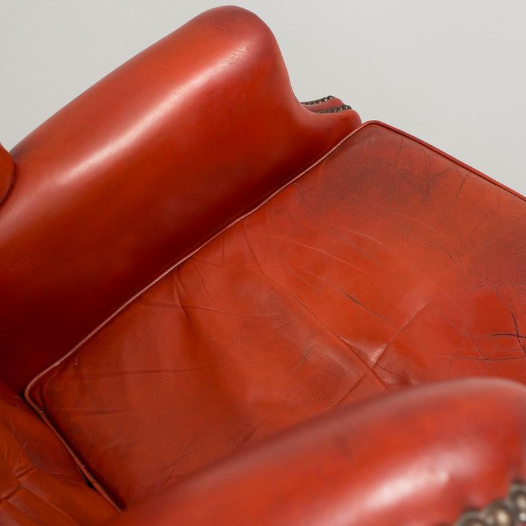 a 20h Century red lether armchair.