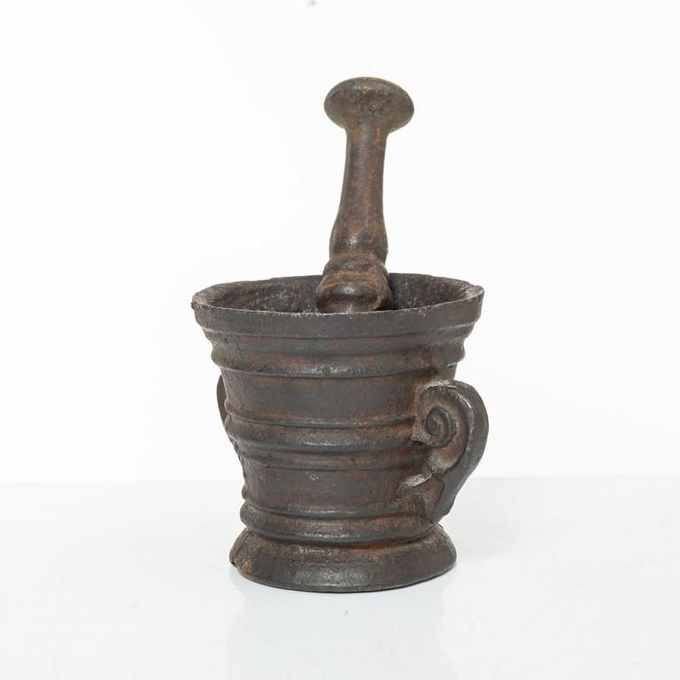 A cast-iron mortar and pestle of renaissance-type, 17th century.