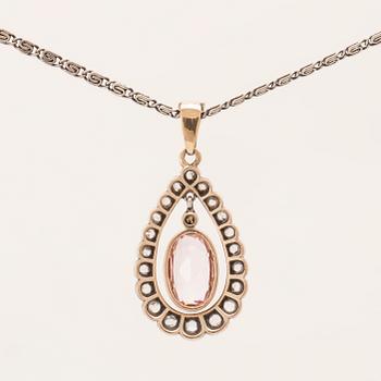 An 18K gold and silver necklace set with an oval faceted morganite and rose-cut diamonds.
