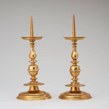 A pair of Baroque 17th century brass pricket candlesticks.