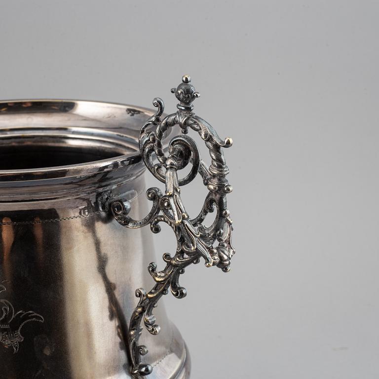 A silver plated winecooler.