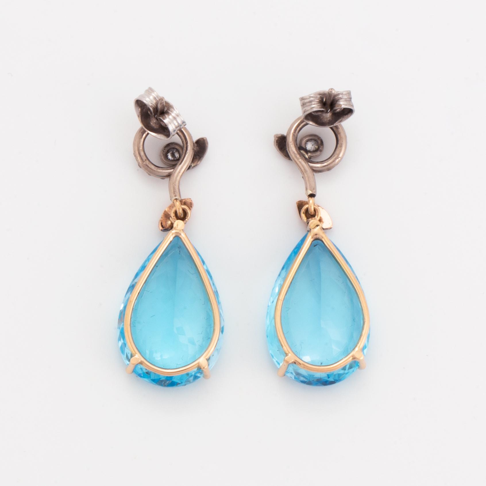 Drop shaped blue topaz and diamond earrings.