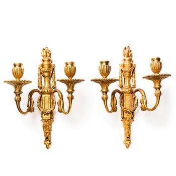 A pair of Louis XVI late 18th century gilded bronze two-light wall-lights.