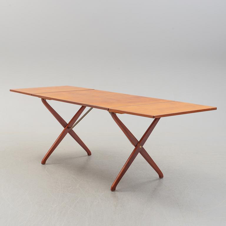 A teak veneer and stained beech dining table, mid 20th Century.