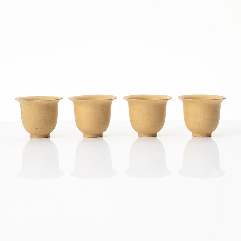 A set of a yellow yixing 'gongfu' teapot and four cups, China, 1980s.